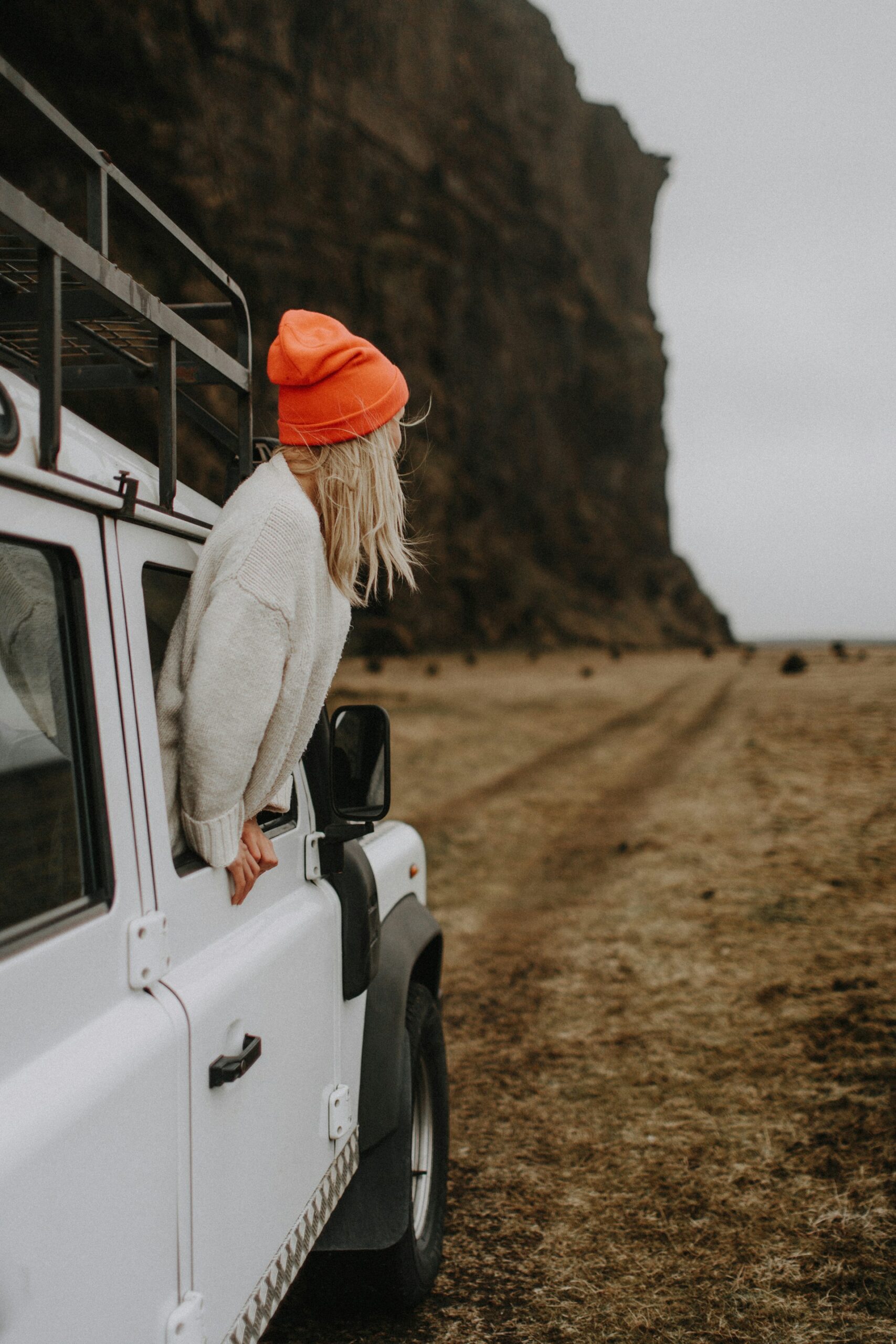 woman hanging out a vehicle looking ahead